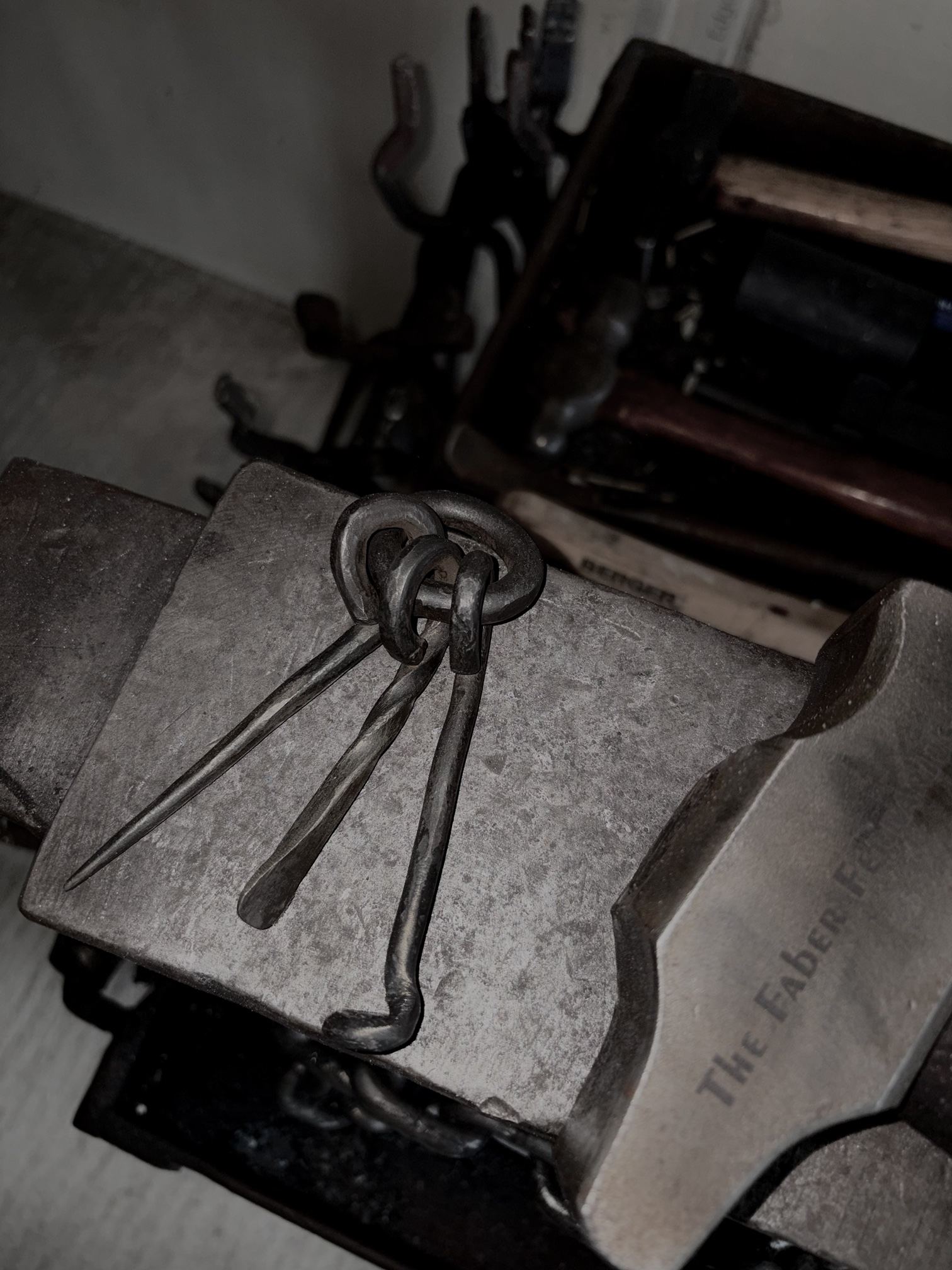 The pipe tool set resting on the anvil in the shop.